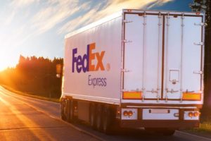 A FedEx trucking showing we help with liability insurance claims when hit by a delivery truck