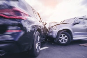a blurred image of two SUVs colliding on the road